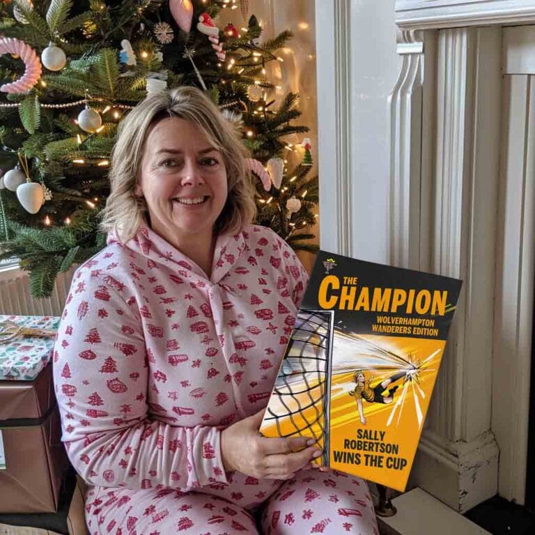 Smiling customer at Christmas holding her personalised Wolverhampton Wanderers storybook, Sally Robertson Wins The Cup